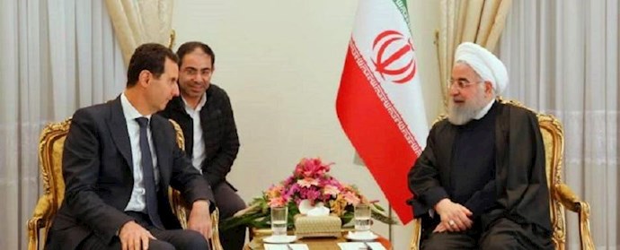  محمد القصير، في صورة نادرة بين الرئيسين الايراني حسن روحاني والسوري بشار الأسد، العام الماضي بطهران