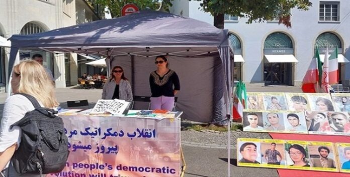 تضامنا مع الانتفاضة الوطنية الایرانیة طاولة كتب ومعرض لصور الشهداء في مدینة زيورخ، سويسرا